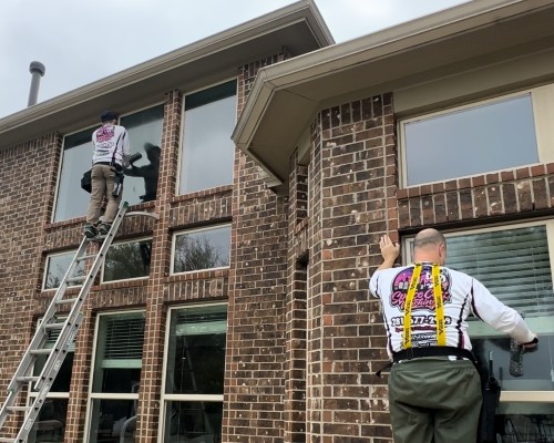 Window cleaning service being performed by Space City Washing Techs